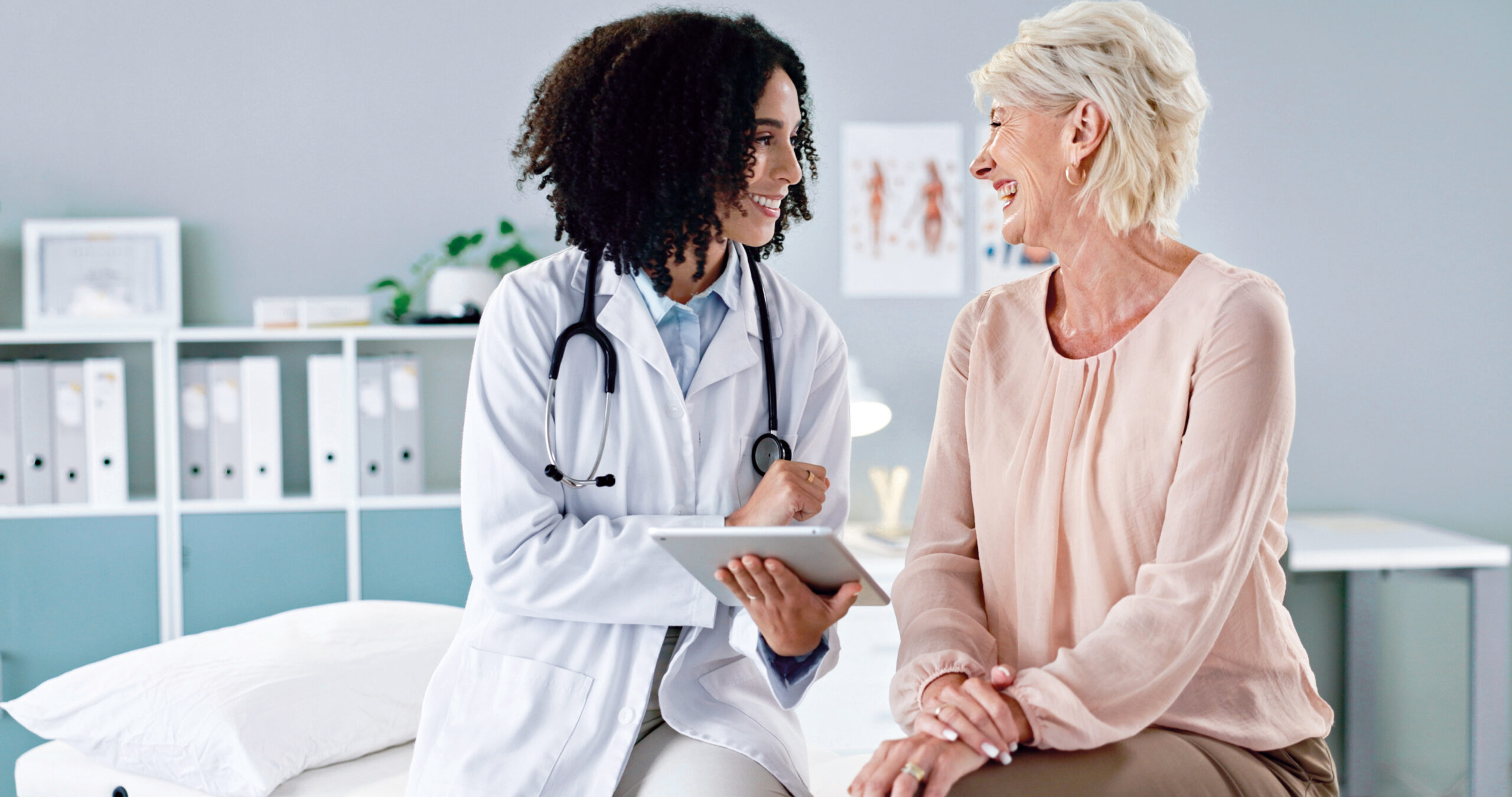 Happy woman, doctor or consulting patient with tablet in checkup for medical results, diagnosis or prescription at hospital. Female person talking to client for consultation, help or advice at clinic