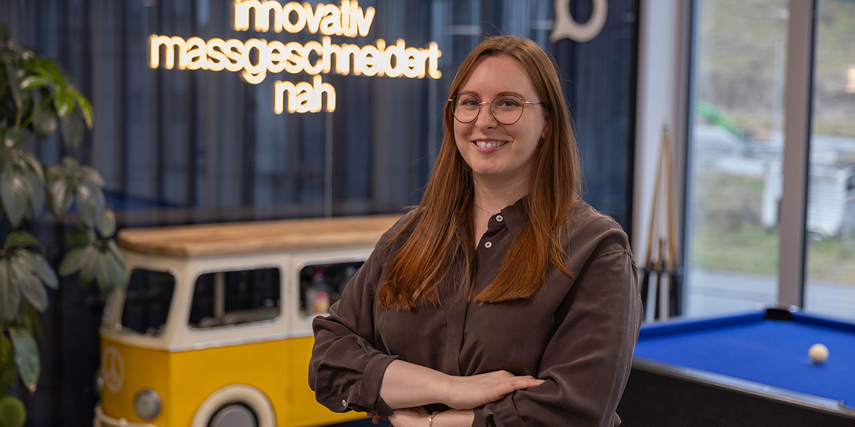 Chantal Schoch stands in the Voicepoint office and smiles at the camera.