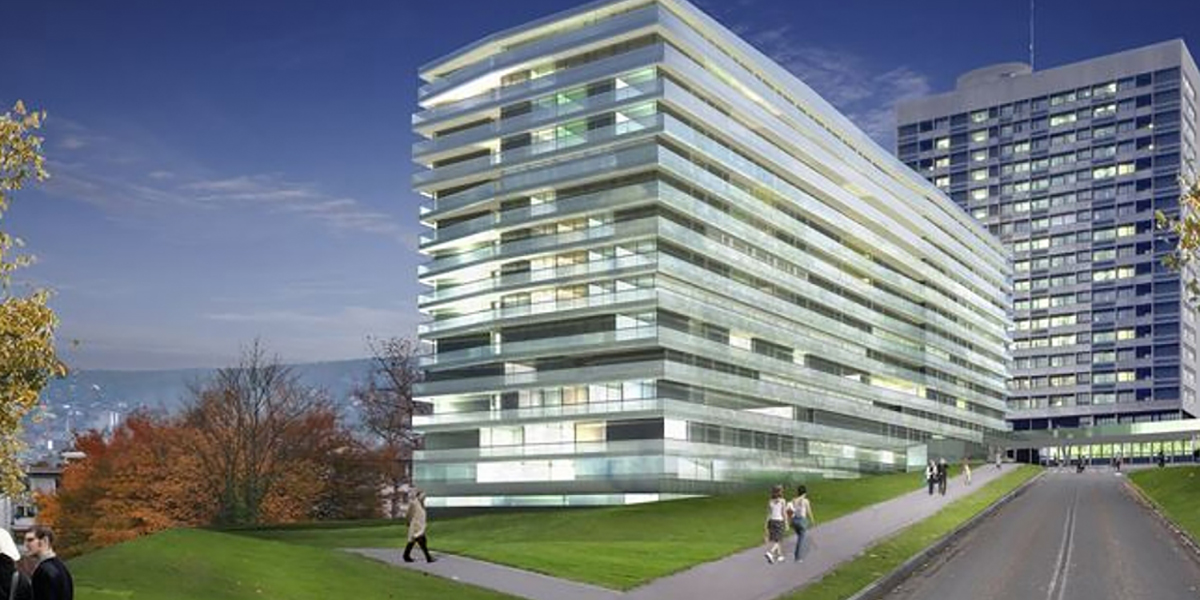Modernes Gebäude des Stadtspitals Zürich mit verglaster Fassade im Vordergrund und Hochhaus im Hintergrund.